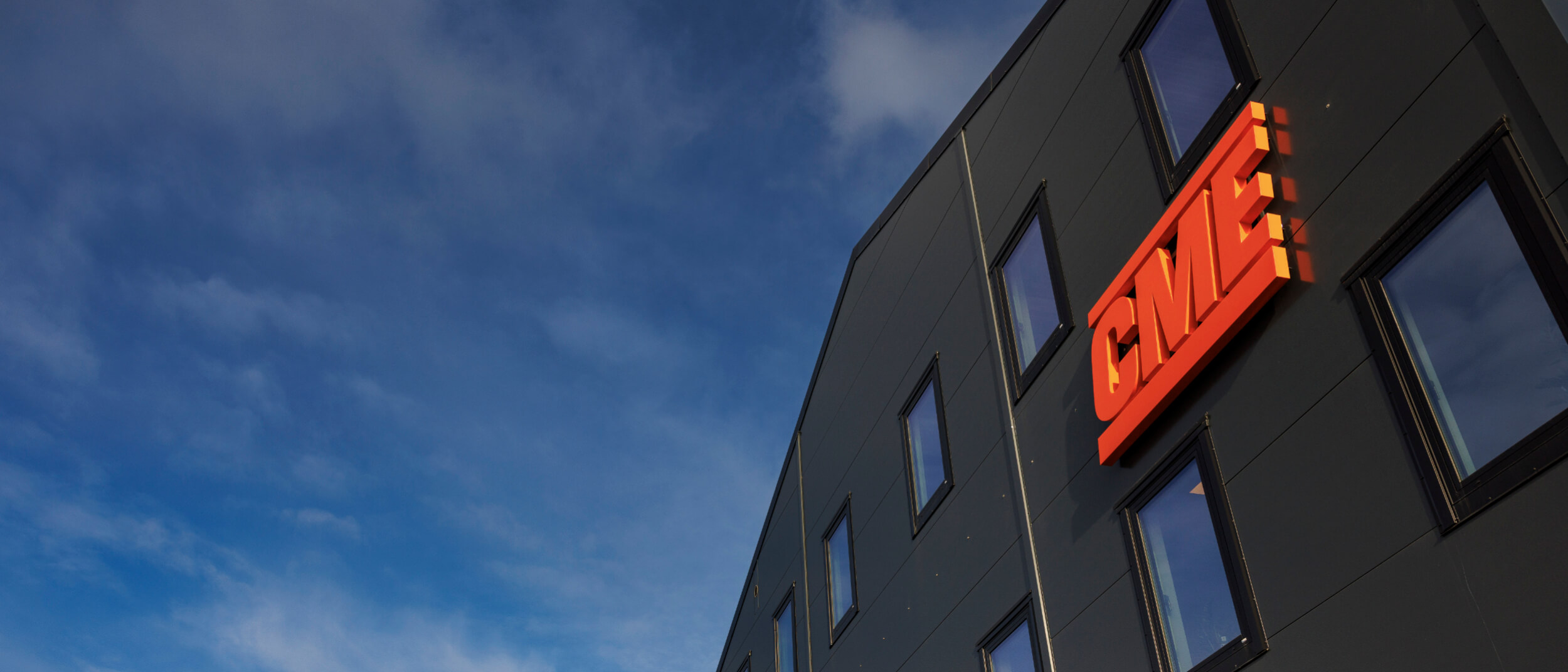 CME Kungälv facility seen from the front with the CME orange logo on the side of the building.